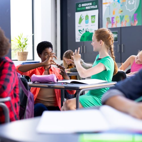 happy-diverse-female-school-teacher-and-schoolgirl